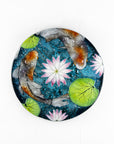 A fused glass round panel featuring hand-painted koi carp design with waterlilies and marine blue background.
