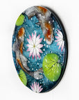 A fused glass round panel featuring hand-painted koi carp design with waterlilies and marine blue background.