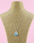 A fused glass pedant necklace, hung o a sterling silver chain, handmade in pastel, spring colours.