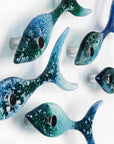 Side image of five fused glass fish, handmade in coastal colours, creating an ocean inspired wall art display.