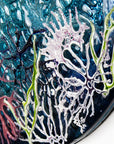 Details on a round fused glass wall panel, with hand-painted john dory design in vibrant organic colours and textures.
