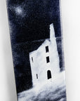 A close up of a fused glass panel featuring a monochrome design of a Cornish tin min.