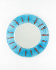 Circular fused glass mirror, featuring circular design of copper fish with an aqua blue colour-way, creating a coastal and ocean inspired wall art design.
