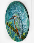 Side image of a round fused glass wall panel, with hand-painted kingfisher design in vibrant organic colours and textures.
