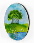 Fused glass round panel, inspired by the Nearly Home Trees in Devon, designed in bright summer greens.
