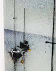 A close up of two boats on a fused glass oblong art frame with hand-painted sailboat design in a soft coastal colour-way.