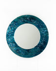 Circular fused glass mirror, featuring teal blue textured waves, creating a coastal and ocean inspired wall art design.