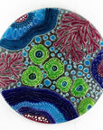 Fused glass round wall panel with hand painted design of a coral reef. Organic and vibrant ocean colours.