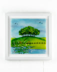 Fused glass art frame with countryside design and vibrant greens.