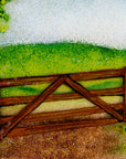 Fused glass art frame with a countryside scene in vibrant colours, focused on a wood gate.