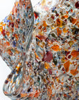 details of a fold form fused glass vase, made with recycled crushed glass in warm colours to create a stunning piece of art.