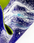Close up details of an opaque ocean inspired fused glass fold form vase with bright coastal colours and texture.