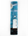Fused glass wall panel featuring a Cornish lighthouse design with a teal blue background and full moon design.