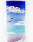 Details of fused glass wall panel featuring a Cornish tin mine, with a vibrant sunset sky and soaring gulls.