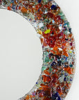 Details of fused glass round mirror, made from recycled glass in sunset orange and reds