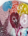 Details of hand-painted anemone in bright pinks on a fused glass round wall panel.