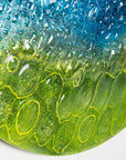 Fused glass abstract round panel details with coastal yellows.