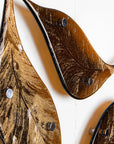Close up of fused glass drift of leaves as a gorgeous wall art display in autumn browns and golds.