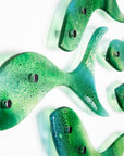Close up of fused glass shoal of fish in a sea green and aqua colour-way.