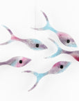 Fused glass shoal of fish on a wall, handmade in bright pinks and coastal blues.
