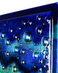 Bubbled detailing on abstract and bright fused glass wall panel, inspired by the ocean, with coastal colours.