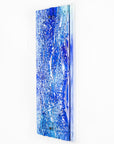 Fused glass ocean inspired wall panel with texture and bright blues.