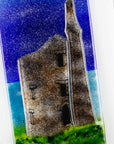 Details of small fused glass wall panel, featuring a Cornish tin mine design, with a coastal moonlight sky.