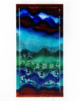 An abstract and bright fused glass wall panel, inspired by the atmosphere of the ocean, with coastal colours and bubbled detailing.