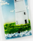 Details of a fused glass wall panel, made with a lighthouse design by the coast. Stunning coastal hues, a stunning hand-made piece of wall art.