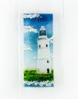 A fused glass wall panel, made with a lighthouse design by the coast. Stunning coastal hues, a stunning hand-made piece of wall art.