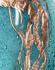 Details of hand-etched copper jellyfish on a fused glass wall panel, inspired by the sea.