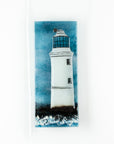 Small fused glass wall panel, featuring a lighthouse design in a teal blue colour-way.