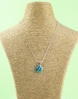 Fused glass pendant necklace, handmade with spring greens and hung on a sterling silver chain.