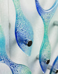 Close up of fused glass fish blue and green wall art with fittings