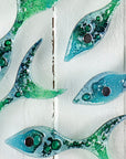 detail of gwithian mini shoal featuring fused glass fish in blues and greens