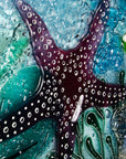 Close up of dark pink starfish on a fused glass extra large art frame, ocean reef inspired with coastal colours and texture.