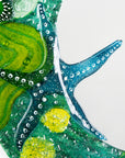 Details of round mirror made from fused glass in ocean inspired design with sea green colours. Handmade, bespoke wall art.