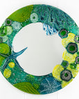 Round mirror made from fused glass in ocean inspired design with sea green colours. Handmade, bespoke wall art.