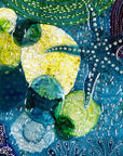 Close up of round wall panel made from fused glass, inspired by the ocean reefs with starfish detailing and coastal colours.