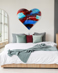 A striking 95cm fused glass hear shaped wall panel handcrafted in Cornish studio in bright reds, aqua blues and lots of textured detailing. Photographed in a bedroom, above the king sized bed to show the size.