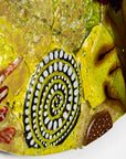 Textural detailing on a fused glass round panel featuring organic autumn inspired patterns and shapes, in a vibrant yellow colour-way, handmade and inspired by the autumnal season.