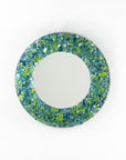A fused glass round mirror, handmade using recycled ocean coloured glass in green and aqua hues. A coastal inspired piece of wall art.