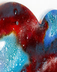 Shadow details on a striking 95cm fused glass hear shaped wall panel handcrafted in Cornish studio in bright reds, aqua blues and lots of textured detailing.