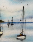 Close up of fused glass art frame featuring hand-painted sailing boats entering a harbour with soaring birds in a soft coastal colour-way.