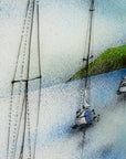 Details of a hand-painted fused glass design of several sailboats anchored, designed in soft coastal colours and presented in a white frame.
