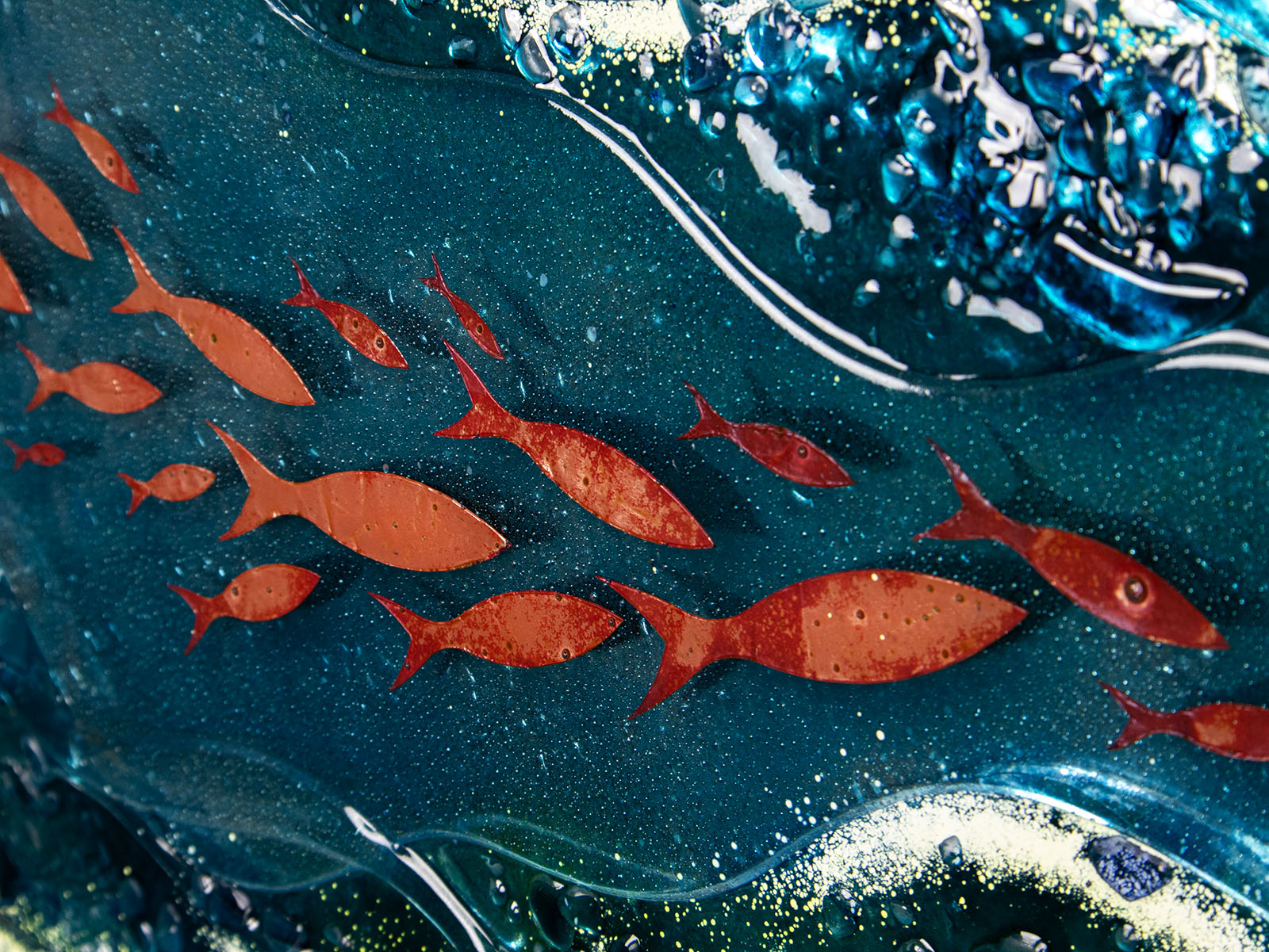 close up of copper fish and teal background with textural detail