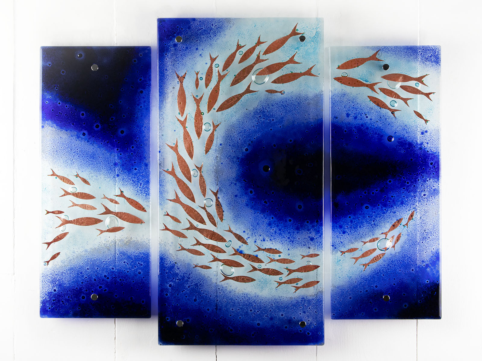 Fused glass triptych featuring a royal blue colour-way, with swirling copper fish, handmade in a beautiful ocean inspired design. 