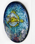 Side image of a round fused glass wall panel, with hand-painted john dory design in vibrant organic colours and textures. 