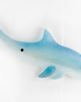 A fused glass sculptural dolphin wall panel, handmade in soft and coastal aqua blue and white.