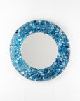 A fused glass round mirror, handmade using recycled crushed glass in ocean blue hues, with lots of organic texture. 